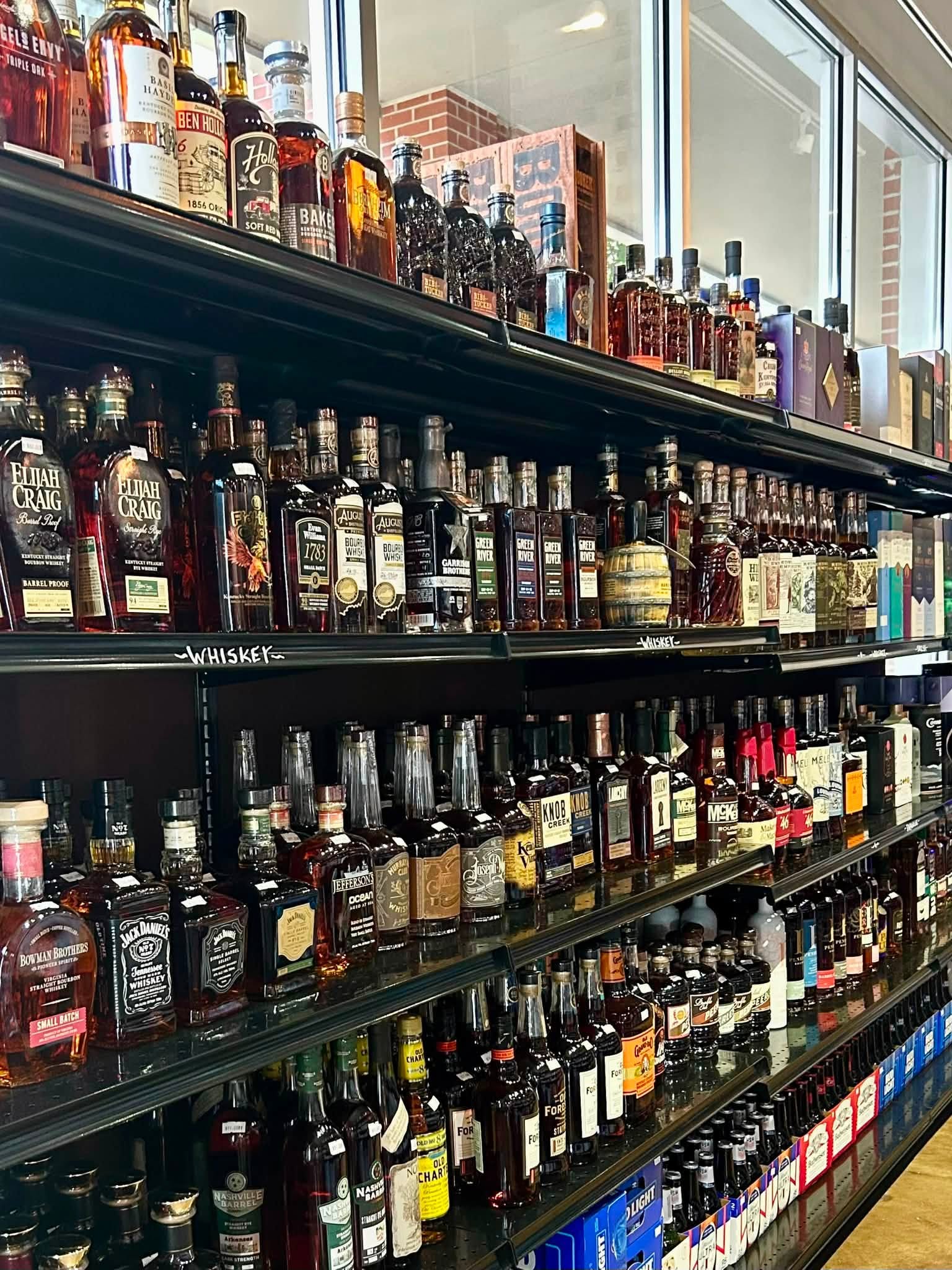 Bourbon and whiskey bottle selection at Mash and Vine Market in downtown Little Rock